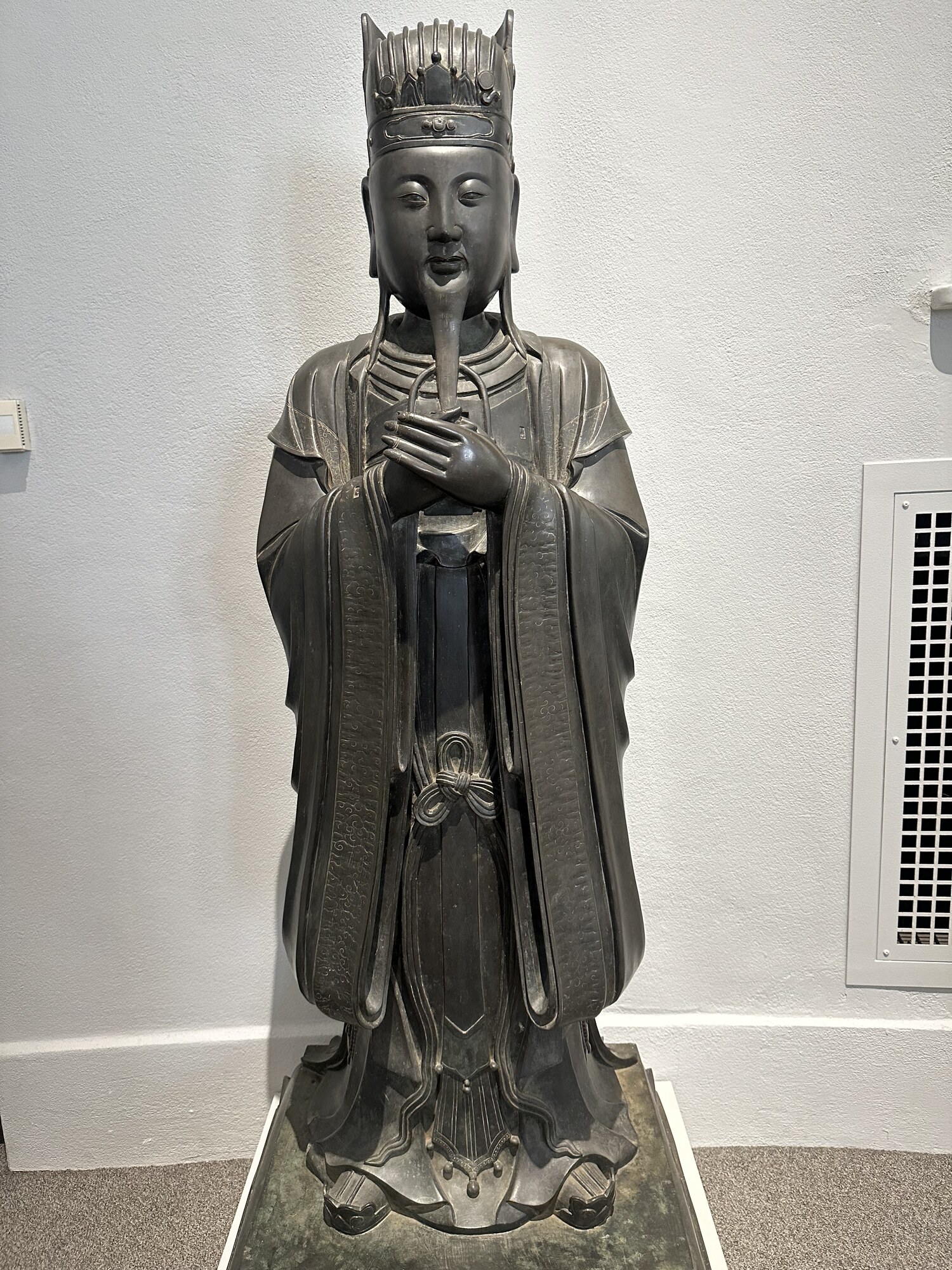 A robed Taoist figure displayed in a museum.