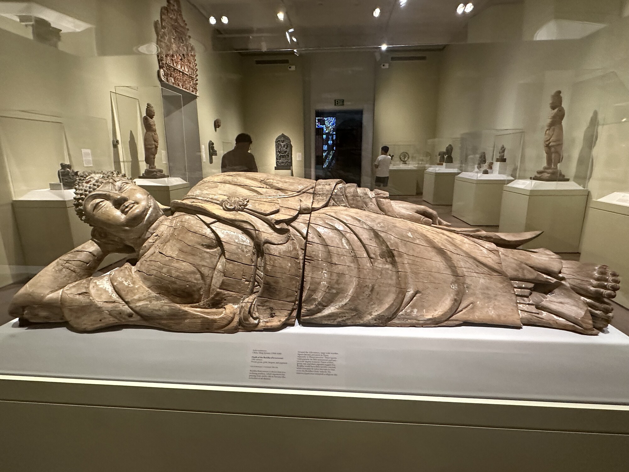 A reclining sculpted figure extending horizontally.