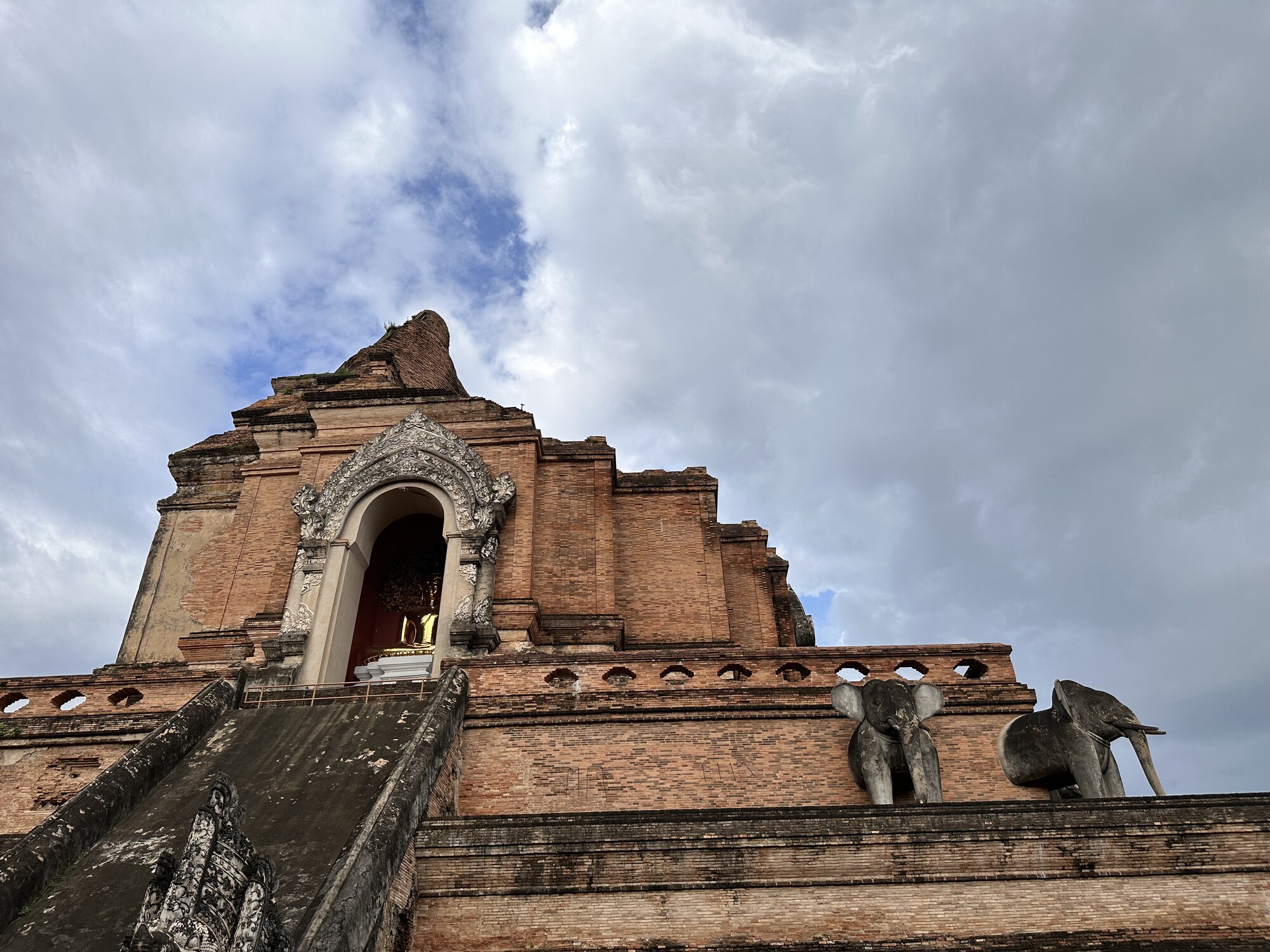A large brick temple with a narrow stairway.