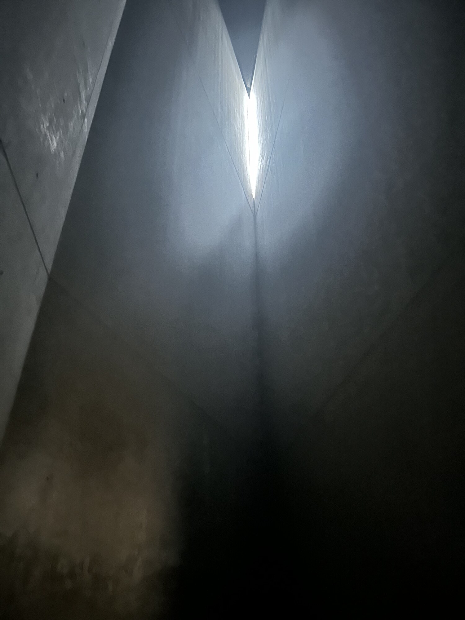 A narrow shaft of light between dark walls.
